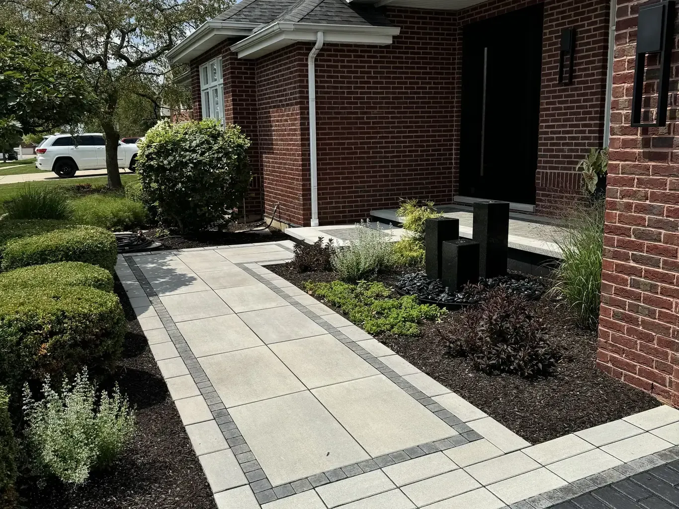 Finished paver driveways in Frankfort by Rodak Landscaping: Frankfort Paver Driveway with Charcoal Accent Border