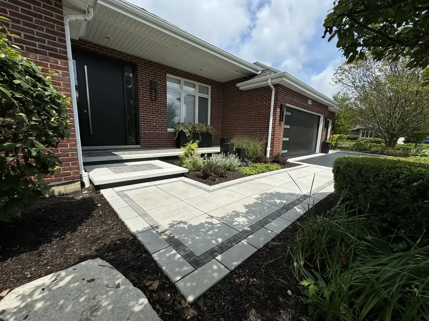 Finished paver driveways in Frankfort by Rodak Landscaping: Frankfort Paver Driveway with Charcoal Accent Border