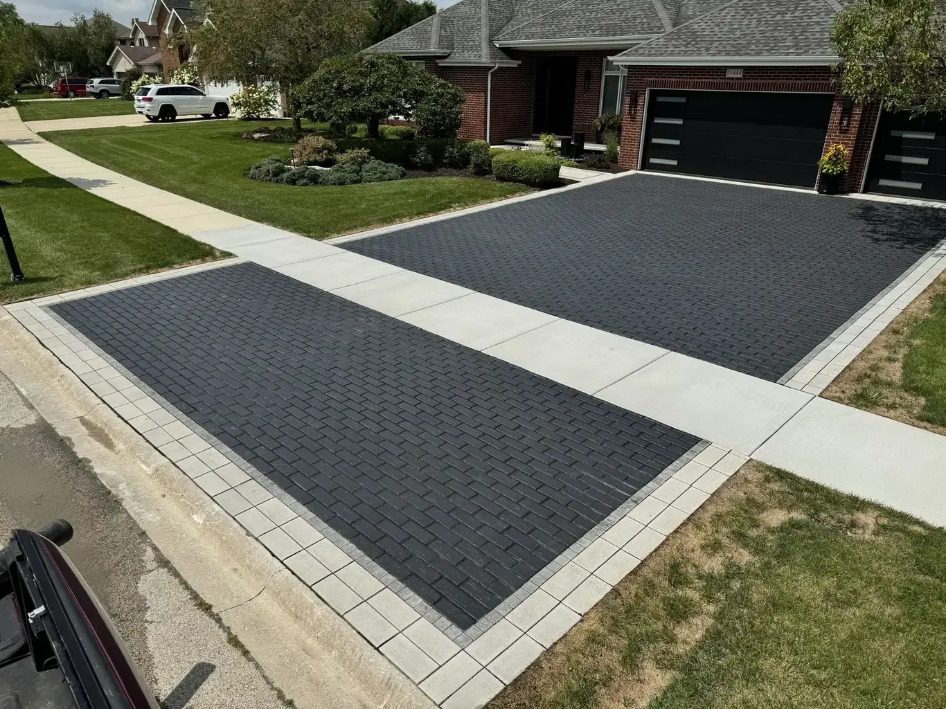 After: Frankfort Paver Driveway with Charcoal Accent Border by Rodak Landscaping