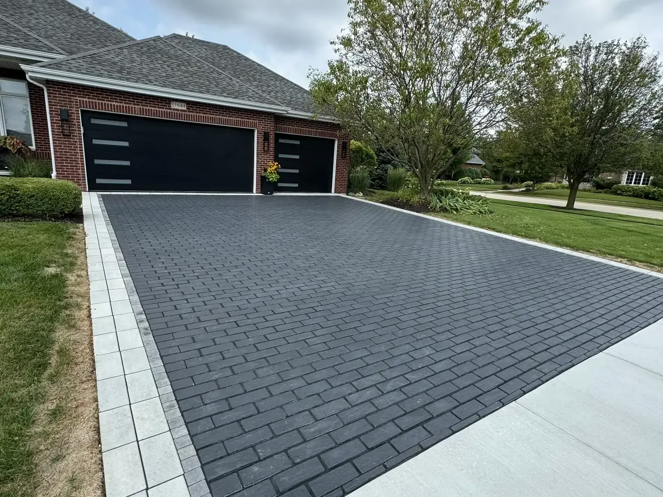 Finished paver driveways in Frankfort by Rodak Landscaping: Frankfort Paver Driveway with Charcoal Accent Border