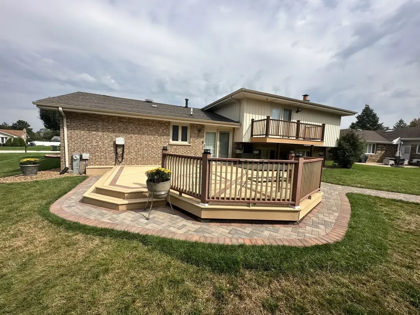 Custom outdoor living build with composite deck and paver patio by Rodak Landscaping