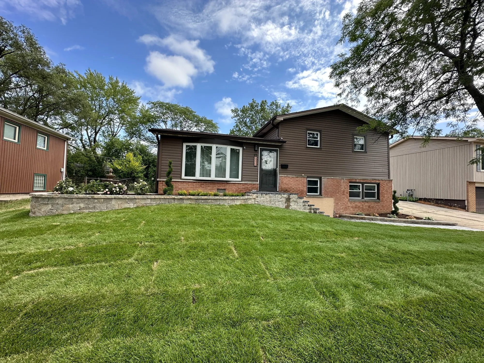 Same Oak Forest front yard after the Rodak Landscaping redesign with clean beds, fresh sod, and new hardscape