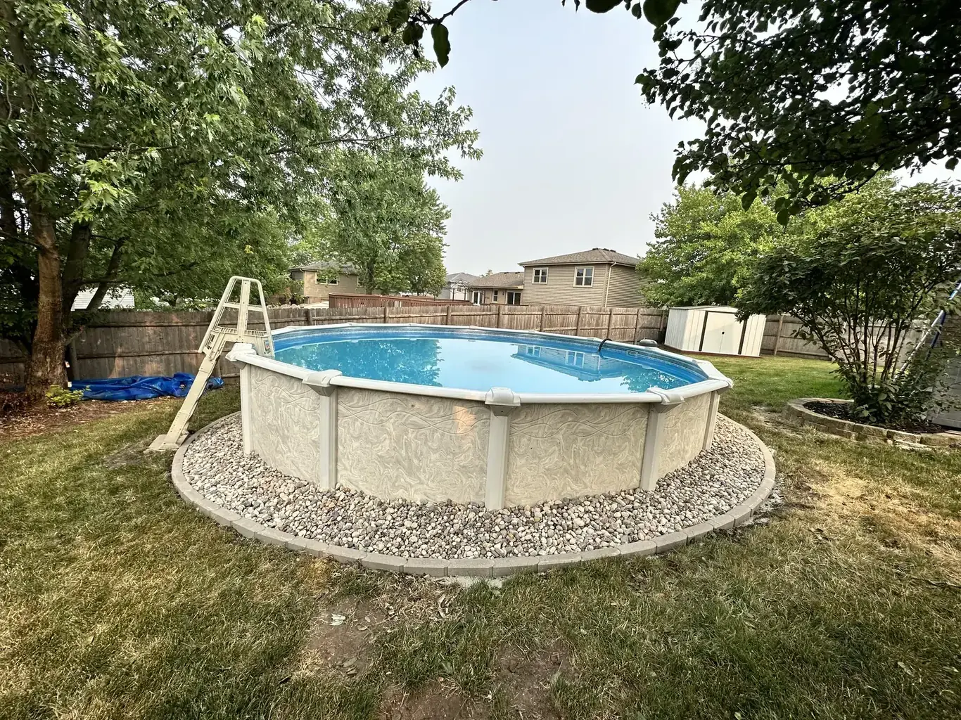 After: Above-Ground Pool with Paver-Edged Gravel Surround by Rodak Landscaping