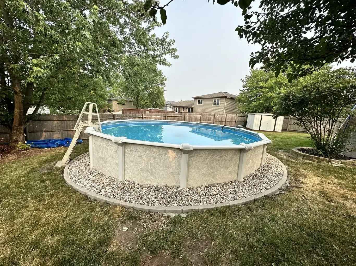 Finished pool patios & surrounds in the southwest suburbs by Rodak Landscaping: Above-Ground Pool with Paver-Edged Gravel Surround