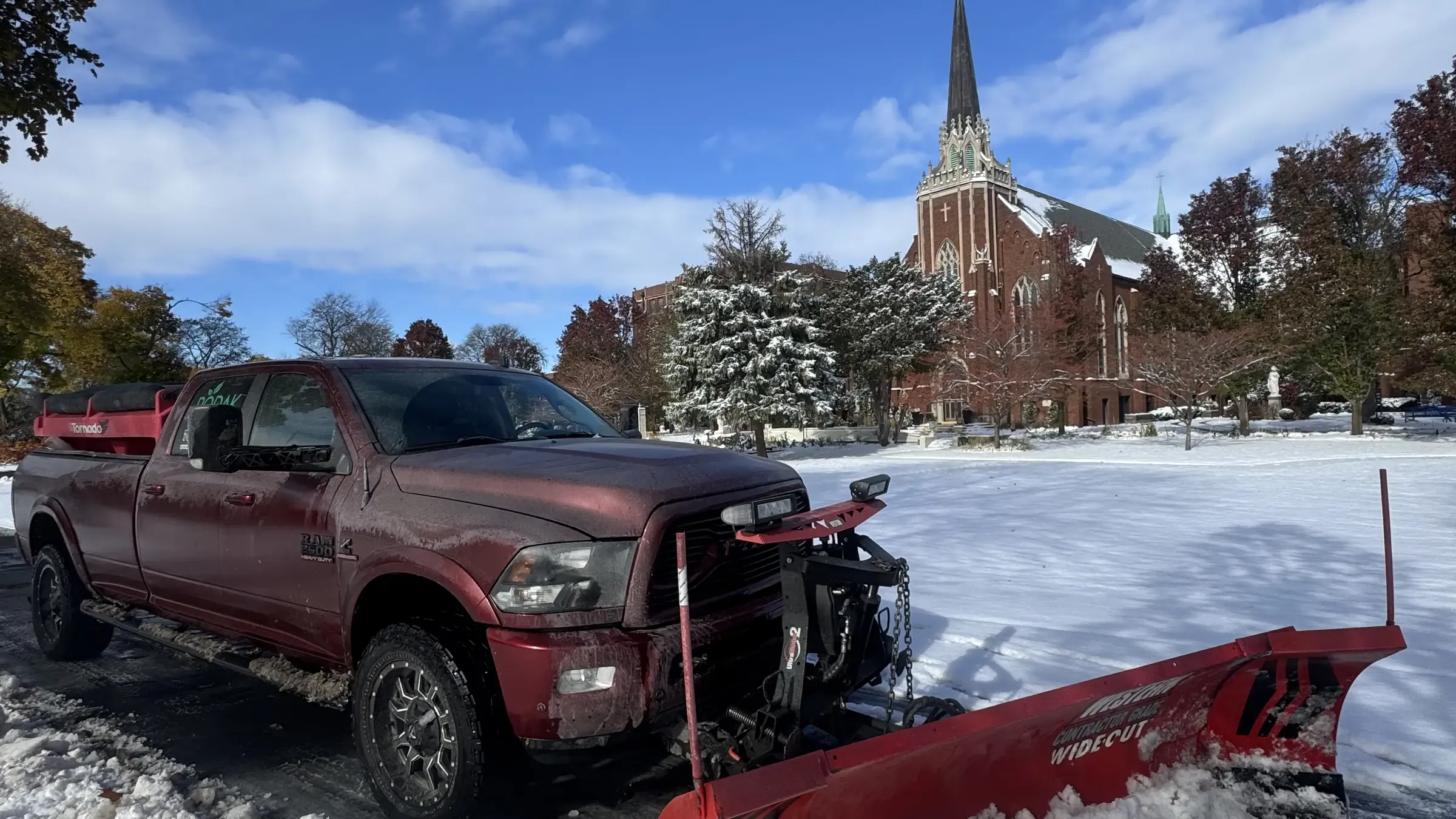 Rodak Landscaping plow truck clearing a commercial lot after a snowfall