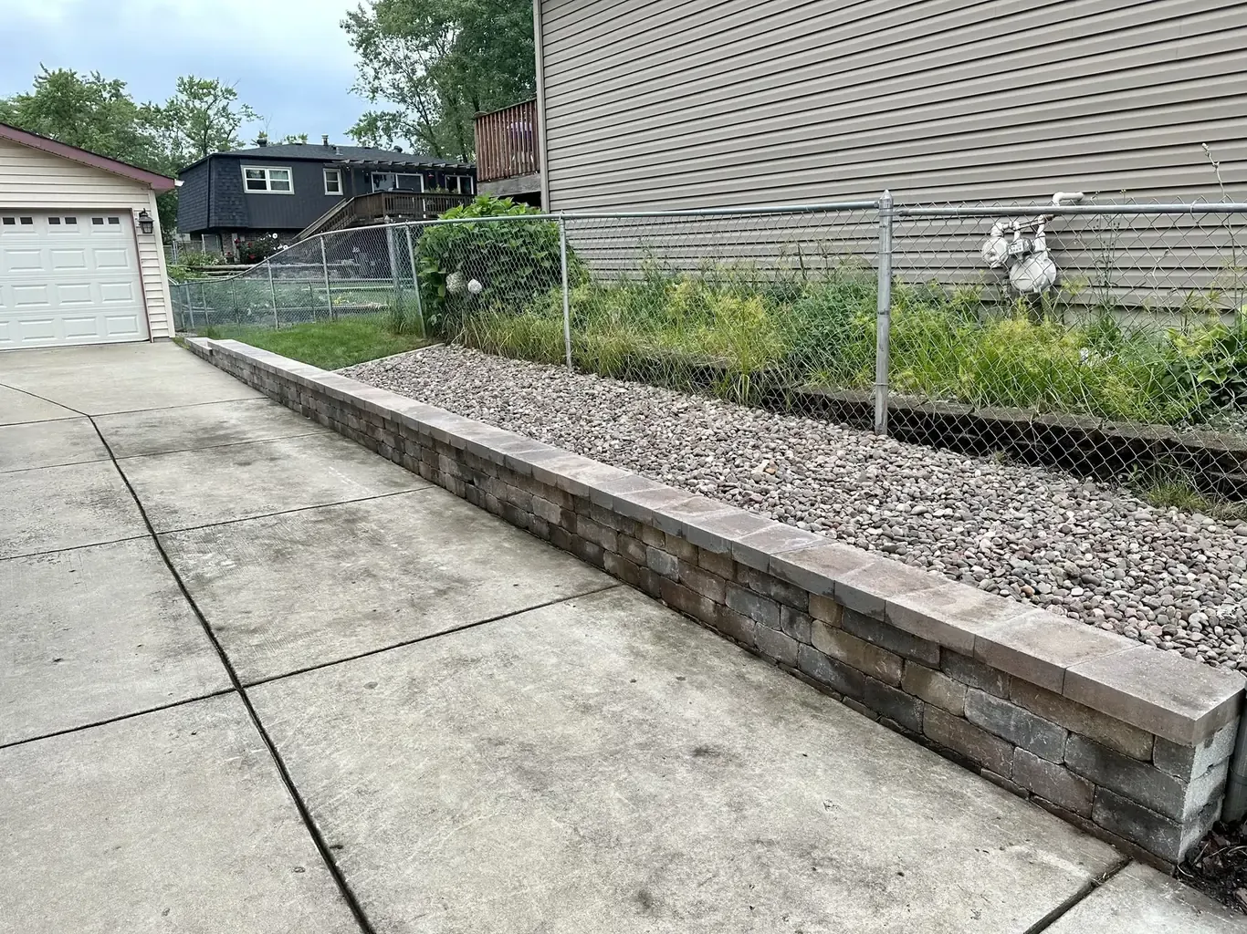 After: Tinley Park Driveway Stone Retaining Wall Rebuild by Rodak Landscaping
