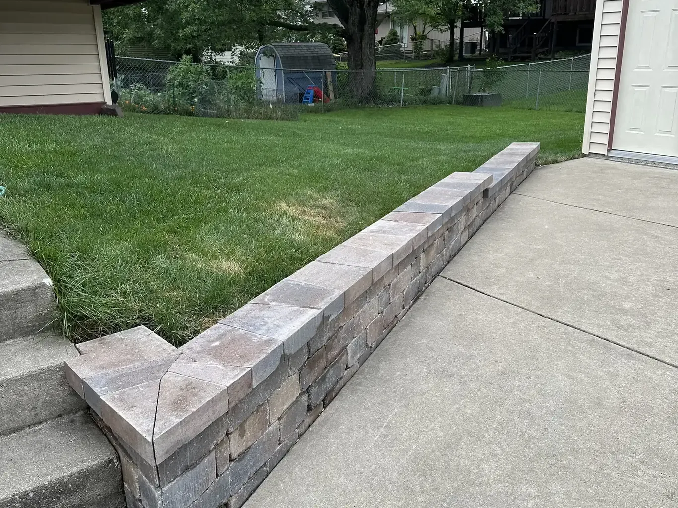 Finished retaining walls in Tinley Park by Rodak Landscaping: Tinley Park Driveway Stone Retaining Wall Rebuild