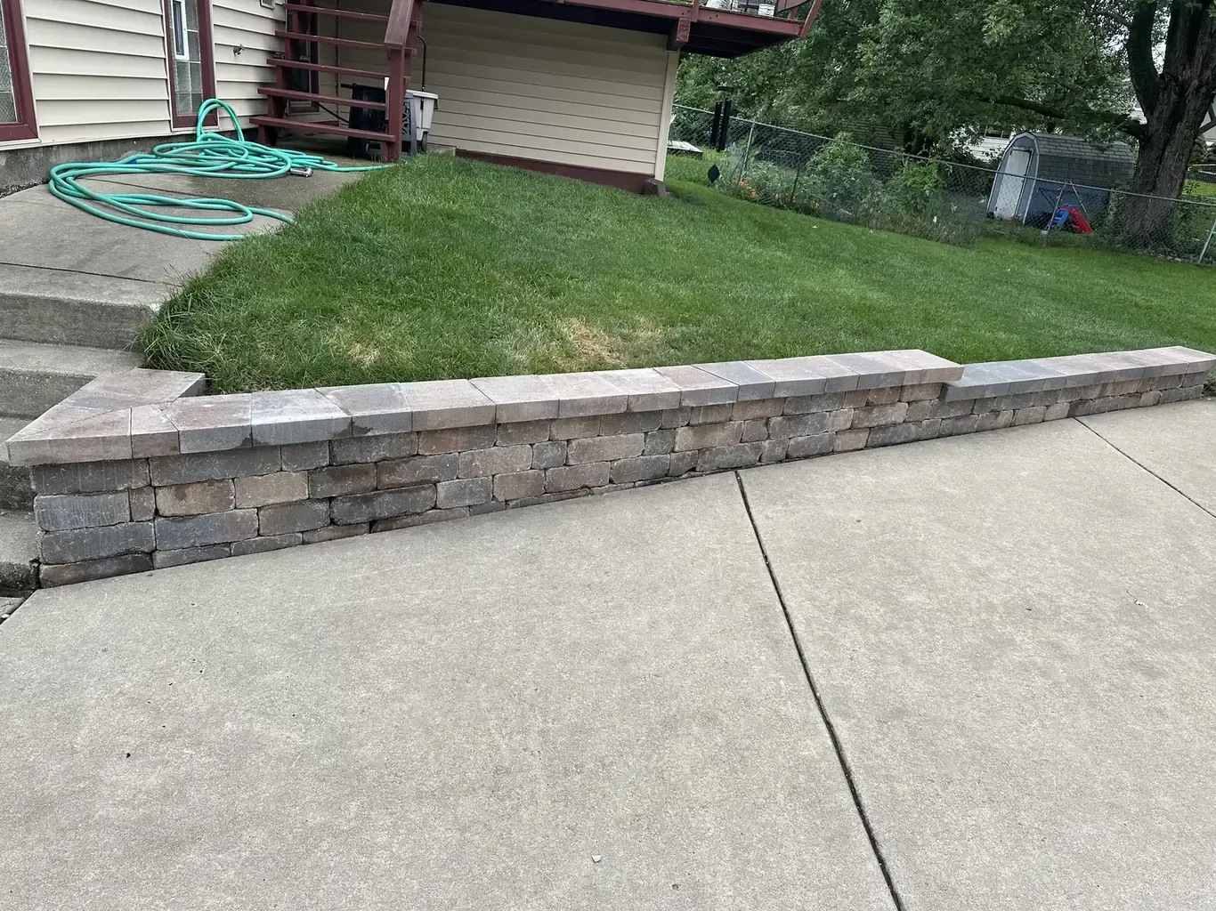 Finished retaining walls in Tinley Park by Rodak Landscaping: Tinley Park Driveway Stone Retaining Wall Rebuild