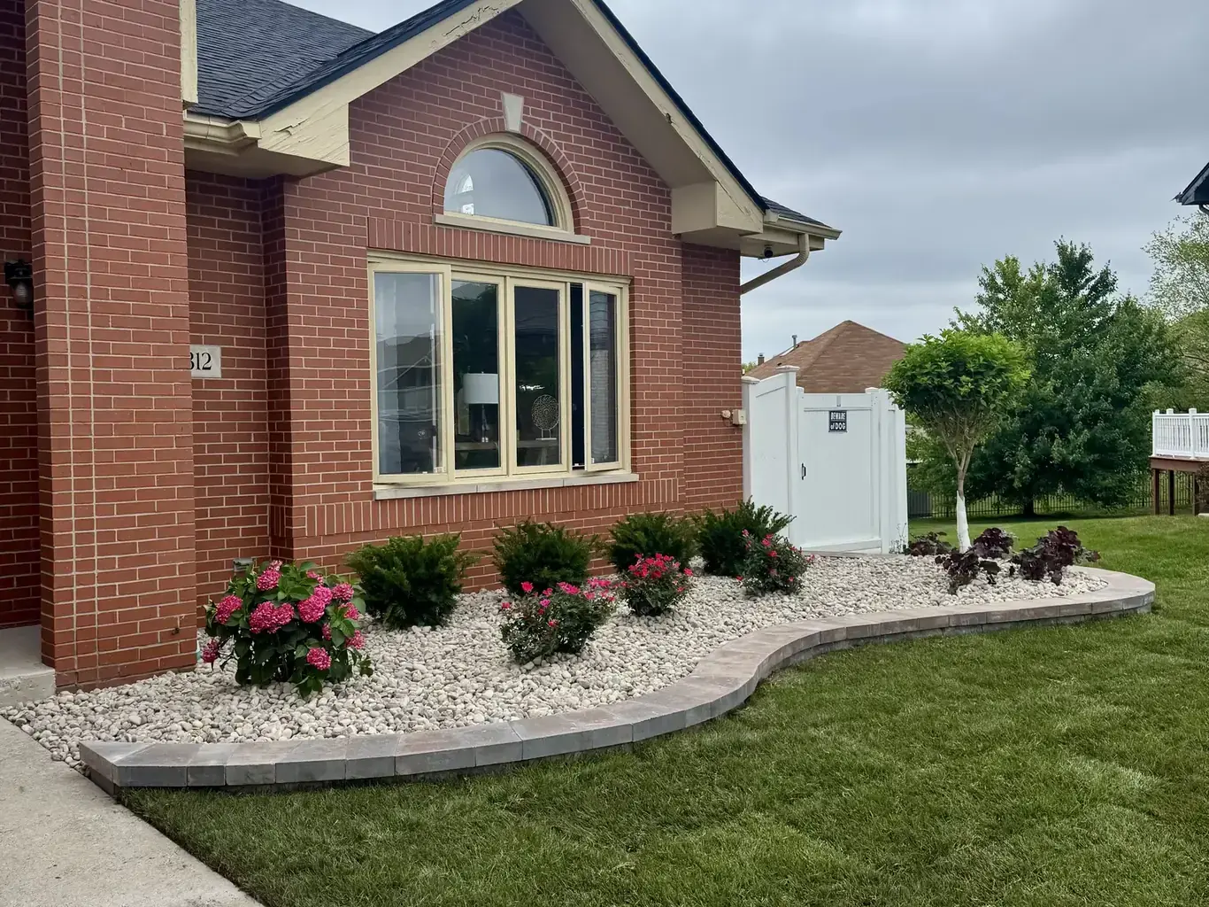 Finished landscape design in Tinley Park by Rodak Landscaping: Tinley Park Curving Bed & Erosion Repair