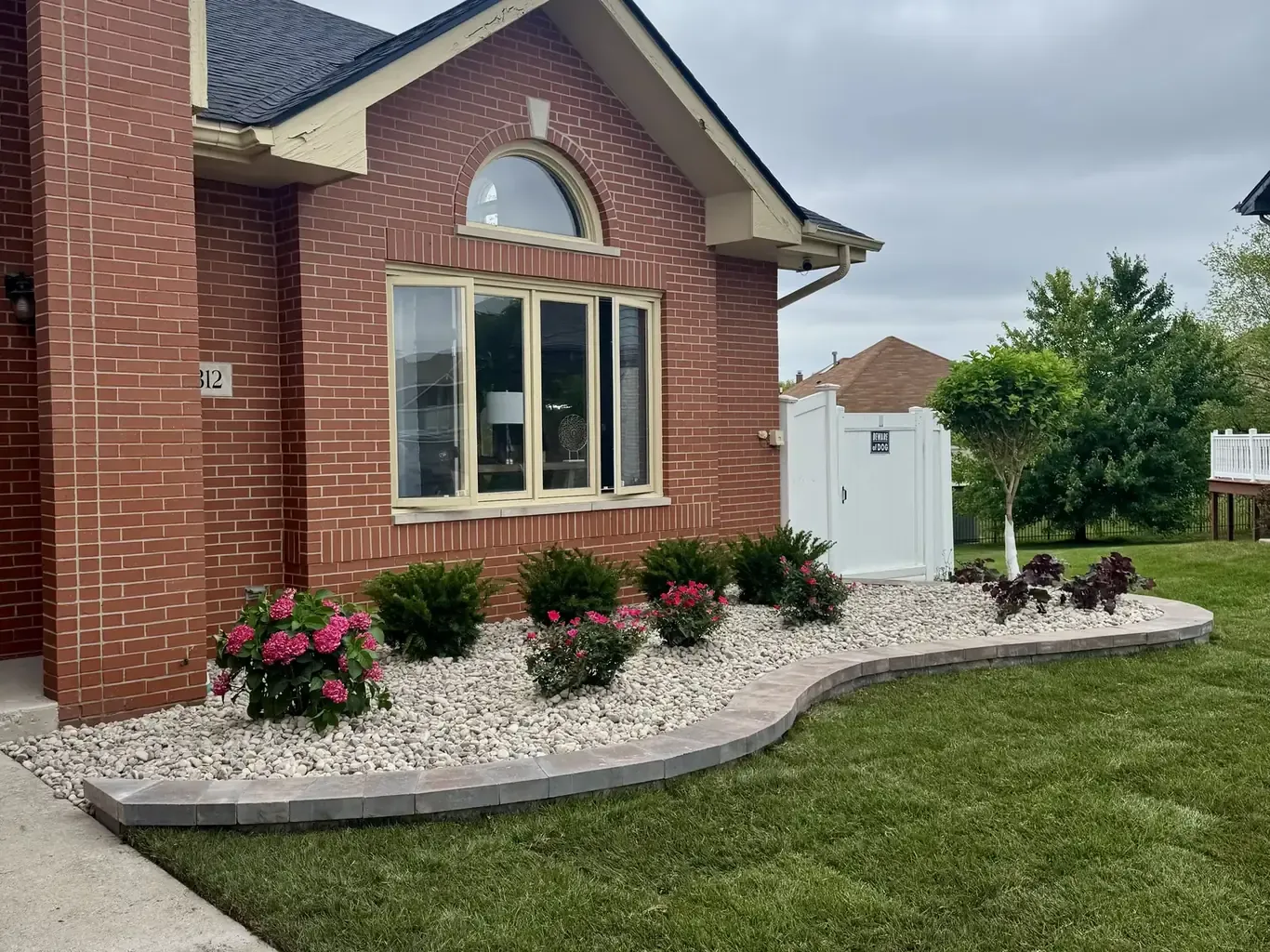 Finished landscape design in Tinley Park by Rodak Landscaping: Tinley Park Curving Bed & Erosion Repair