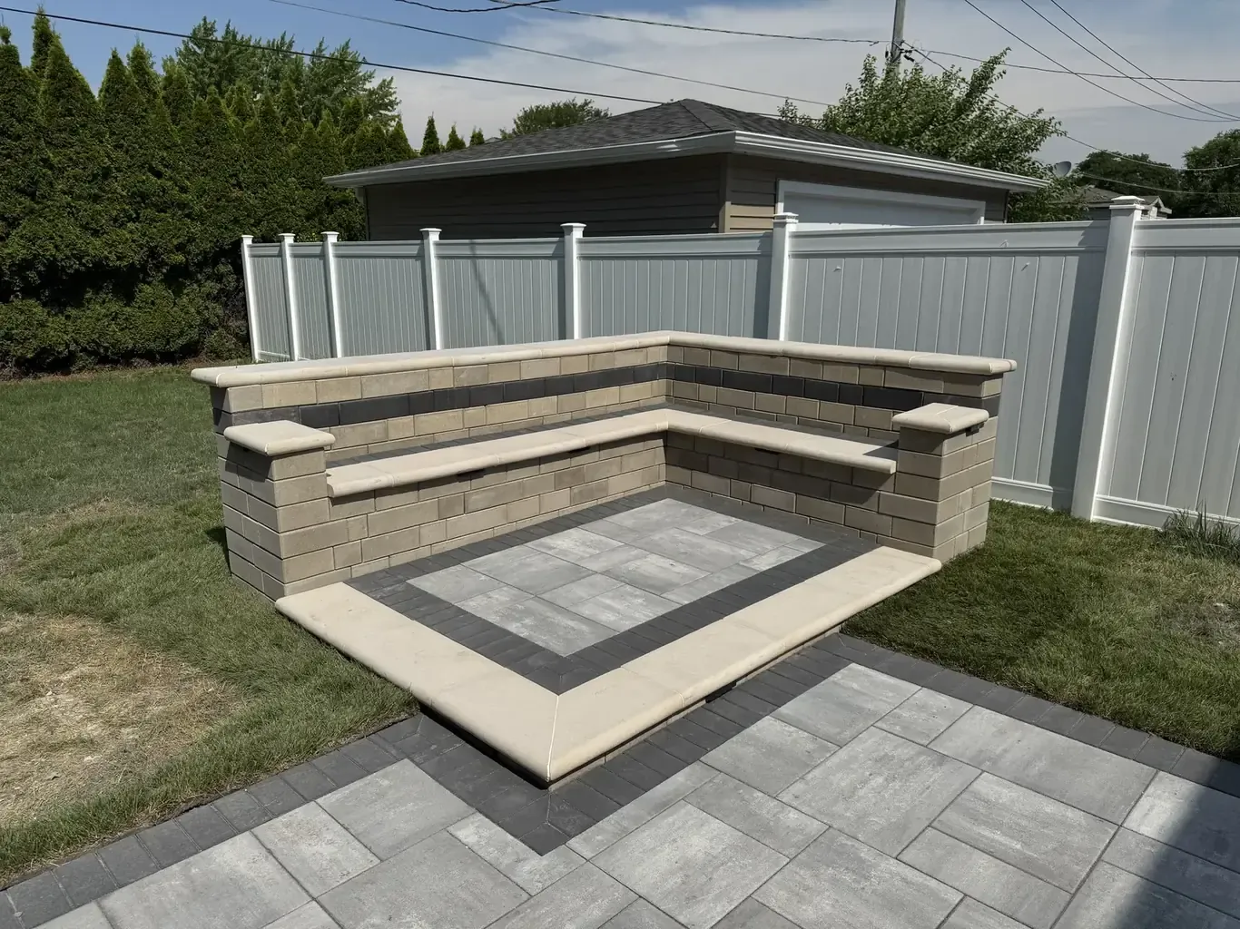 Paver patio with L-shaped sitting wall ready for an outdoor kitchen, built by Rodak Landscaping in Tinley Park